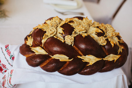 Wedding bread from wheat flour dough on the plate.