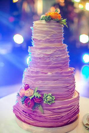 Multilevel wedding cake decorated with edible flowers.