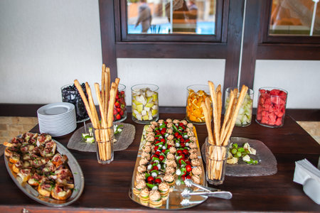 Row of appetizers and starters on the wedding table.