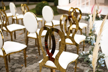 Golden chairs for an outdoor wedding ceremony.の写真素材