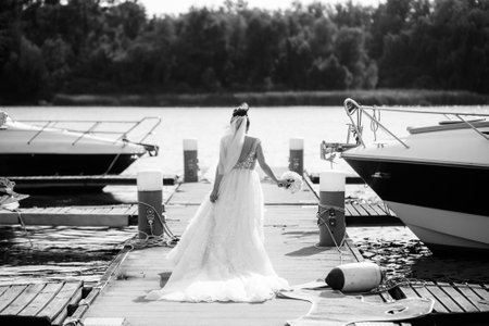 Bride in wedding dress posing on the pier.の写真素材