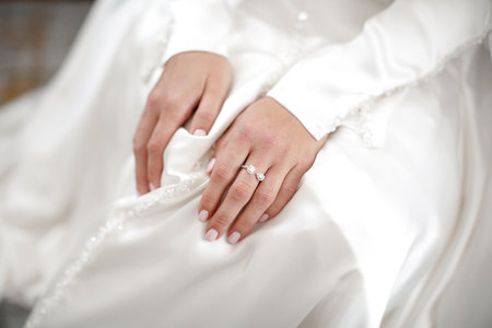 Engagement ring on bride's finger during wedding preparations.の写真素材