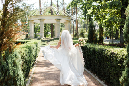 Bride in wedding dress posing in the garden.の写真素材