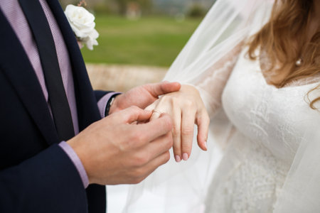 Bride and groom exchange rings at the wedding ceremony.の写真素材