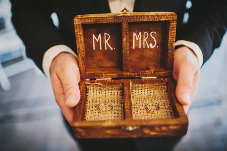 The groom is holding a box for wedding rings.の写真素材