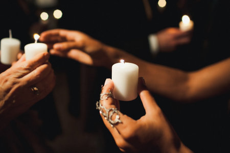 Candle in the hands of a guest at a wedding ceremony.の写真素材