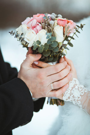 The bride and groom hold a wedding bouquet.の写真素材