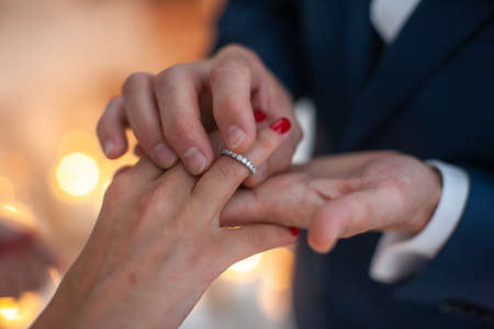 Bride and groom exchange rings at the wedding ceremony.