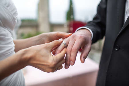 Bride and groom exchange rings at the wedding ceremony.の写真素材