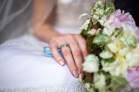 Engagement ring on bride's finger during wedding preparations.の写真素材