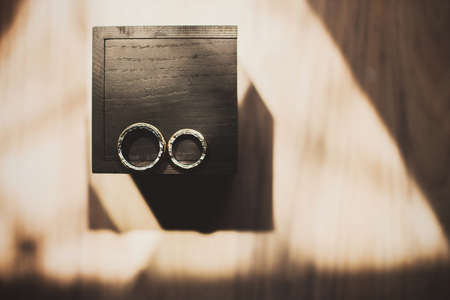 Two vintage wedding rings and wooden box.の写真素材