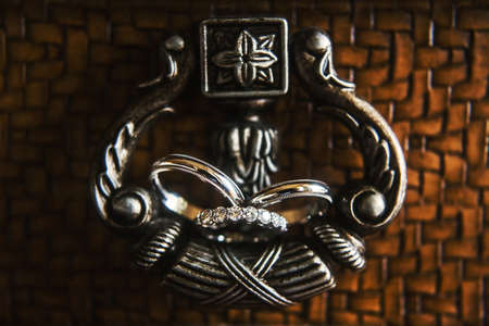 Two wedding rings on a vintage handle.の写真素材