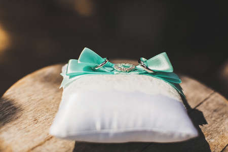Three wedding rings on a lace pillow.の写真素材