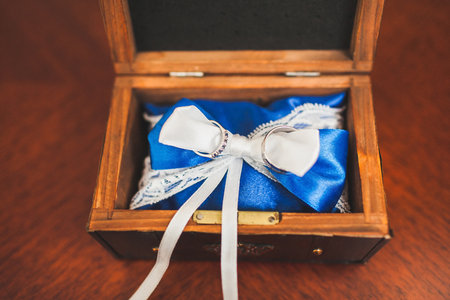 Two wedding rings inside a wooden box.