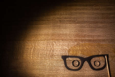 Three wedding rings in cardboard glasses on the table.