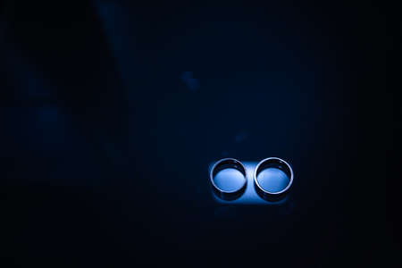 Two wedding rings on a blue background.の写真素材
