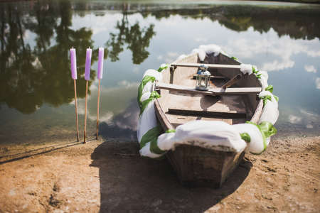 Wedding boat near the shore decorated with colored ribbons.の写真素材