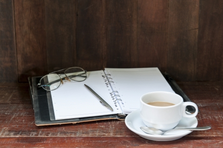 still life with coffee  and notebook on the  wood tableの写真素材