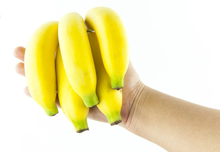 Banana in hand on a white backgroundの写真素材