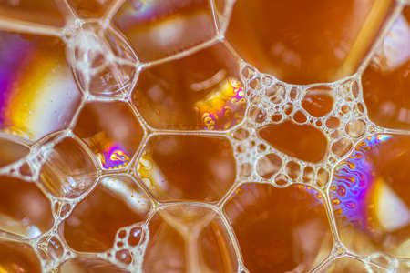 Air bubbles in the water and oil mixture create an artistic and imaginatively designed abstract backgroundの写真素材