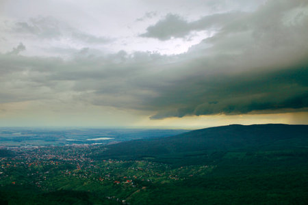 the rain comes over the hills