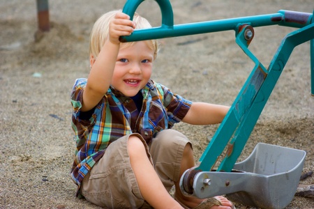 boy playing with digger in the parkの写真素材