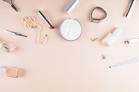 Skin care concept. Femenine accessories, nail polish, hand cream on puffy background. Flat lay. Top viewの写真素材