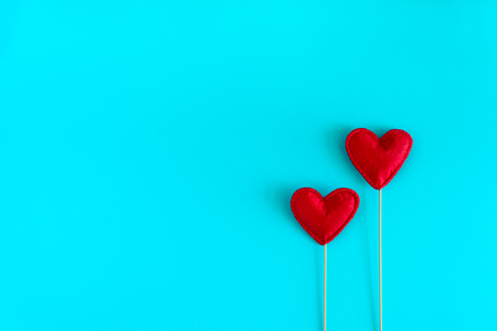Felt love hearts on booth props on blue paper background. Valentine's day celebration concept. Top view. Flat lay. Copy spaceの写真素材