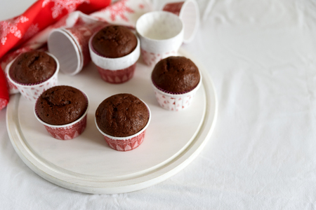 Homemade chocolate muffins (brownies) on white wooden background. Christmas food. Selective focusの写真素材