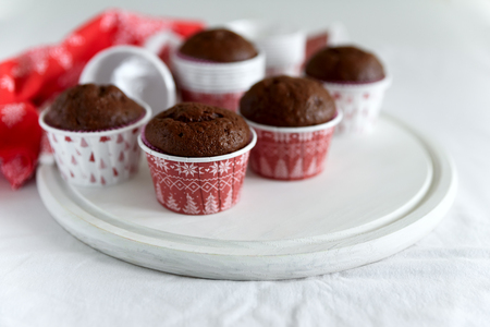 Homemade chocolate muffins (brownies) on white wooden background. Christmas food. Selective focusの写真素材