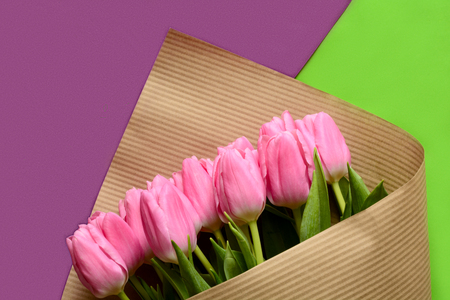 Bouquet of beautiful pink tulips on colorful paper background. Top view. Copy spaceの写真素材