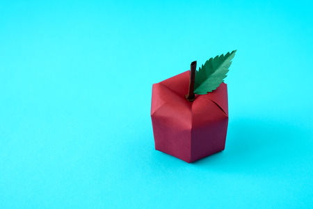 Apple made from paper on blue background. Fresh fruits. Minimal, creative, vegan, healthy or food art concept. Copy space.の写真素材