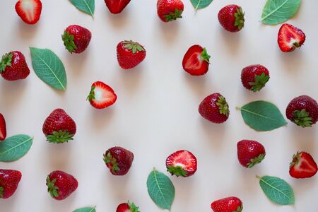 Top view on strawberry with leaves on pink background. Summer nature background. Berries pattern. Flat layの写真素材
