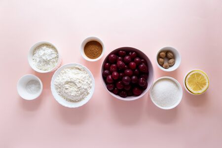 Ingredients for cooking homemade cherry lattice cake on pink background. Traditional american food. Top viewの写真素材