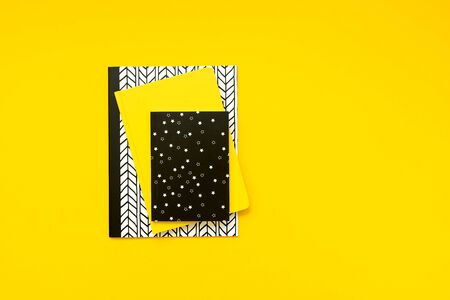 Back to school concept. School supplies: notebooks and pens on yellow background. Top view. Copy space. Flat layの写真素材