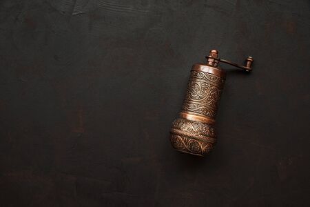 Turkish pepper mill or grinders on dark wooden background. Top view. Copy spaceの写真素材