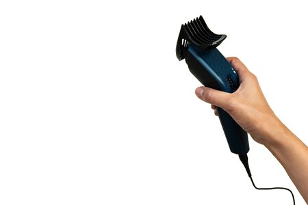 Hand holding electric hair trimmer isolated on white background. Copy space
