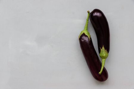 Eggplants on gray wooden background. Top view. Flat lay. Harvesting or healthy food concept.の写真素材