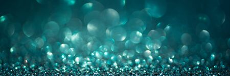 Banner 3:1. Abstract glitter lights on turquoise background. Christmas greating card. Christmas or...
