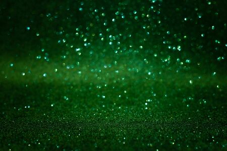 Green abstract glittering background. Defocused lights. Christmas greating card. Christmas or New Year celebration concept. Copy space. Soft focusの写真素材