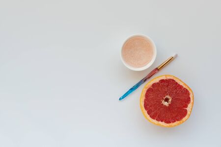 Grapefruit facial mask. Organic ingredients for moisturizing and pore narrowing on white background. Top view. Copy space. Organic home cosmetic conceptの写真素材