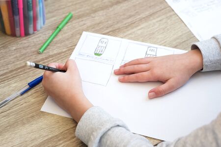 Close-up boy studying  and doing school homework. Distance learning online education or stay at home...