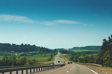 Traffic in high speed on a highway through summer landscape.の写真素材