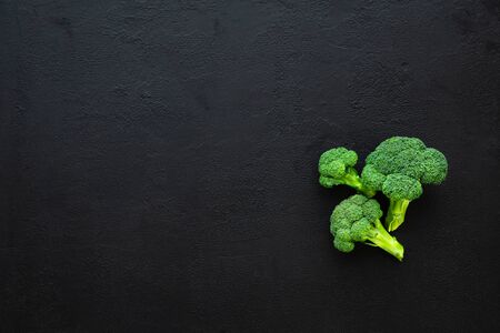 Healthy green organic raw broccoli florets on black backgroundの写真素材