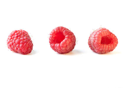 Three ripe raspberry fruits isolated on white backgroundの写真素材