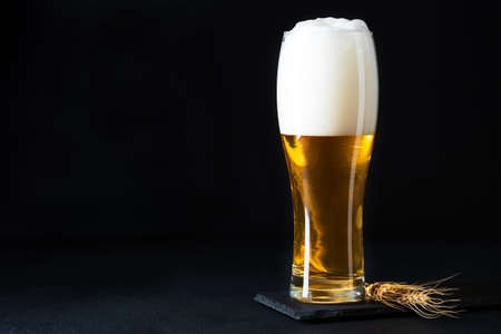 Glass of beer on dark concrete background. Copy spaceの写真素材