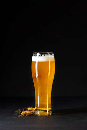 Glass of beer on dark concrete background. Copy spaceの写真素材