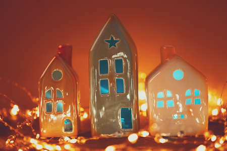 Christmas candle houses against bokeh lights background. New Year or Christmas celebration conceptの写真素材