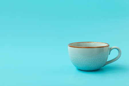 Blue cup of tea on blue backgroundの写真素材