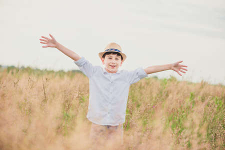 Happy child jumping on green field. Selective focus. Tonedの写真素材
